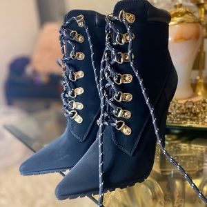 A lace-up boot with a high heel and inner zip closure.
Material: Brand New!